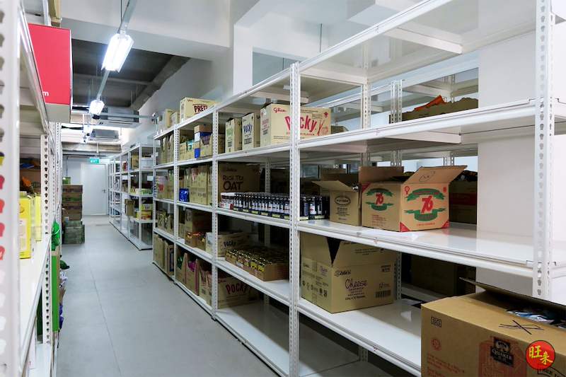 Long run of white boltless shelving stocked with cartons and packaged goods - Boltless Racking - B6 | Wong Lye Racking, Singapore Racking Manufacturer