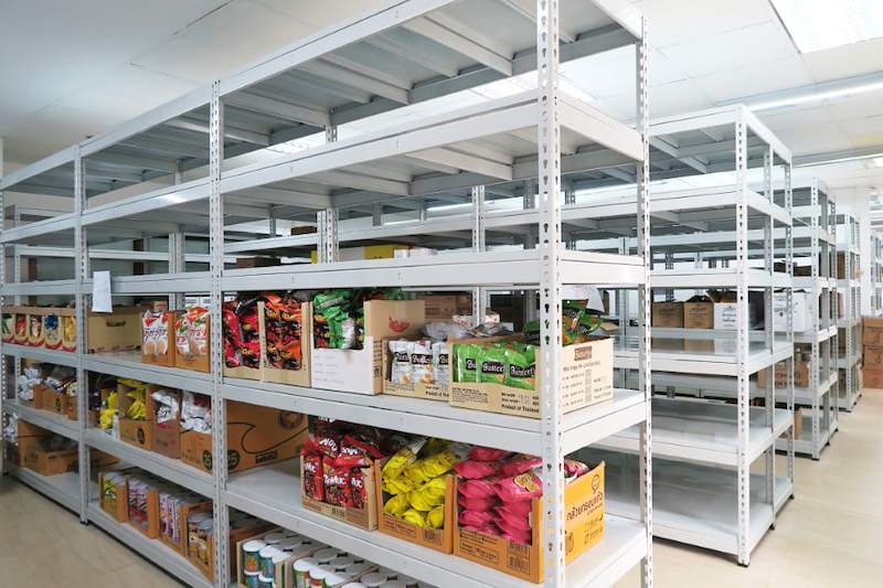 Grey boltless shelving with bagged snacks, canned goods and cartons on the shelves - Boltless Racking - B2 | Wong Lye Racking, Singapore Racking Manufacturer