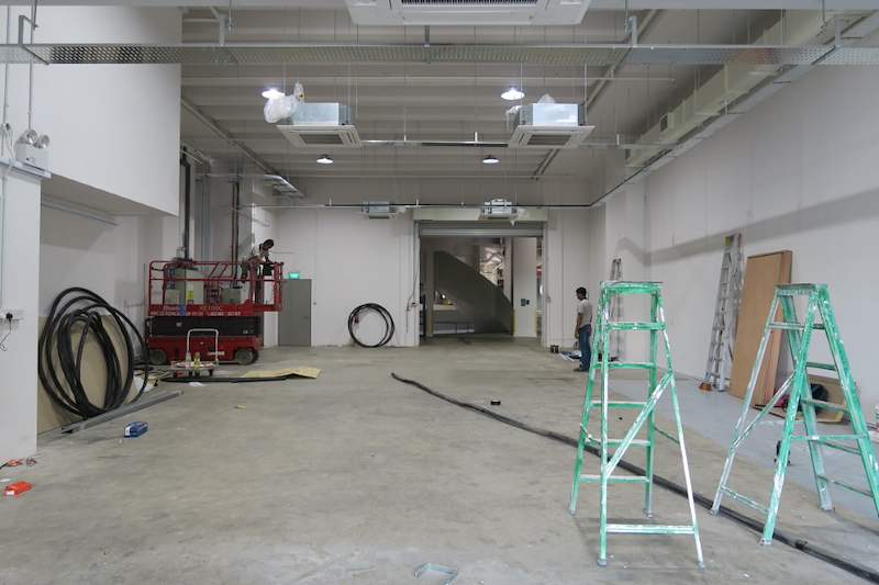 Before: scissor lift and ladders in the empty unit during ceiling works - Boltless Racking - B8 | Wong Lye Racking, Singapore Racking Manufacturer