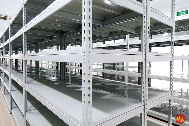 Grey boltless shelving with slotted uprights and steel shelf panels, close view along the row - Boltless Racking - B5 | Wong Lye Racking, Singapore Racking Manufacturer