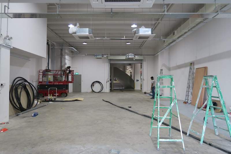 Before: ladders and a scissor lift in the bare unit, ceiling cassette units already fitted - Boltless Racking - B8 | Wong Lye Racking, Singapore Racking Manufacturer