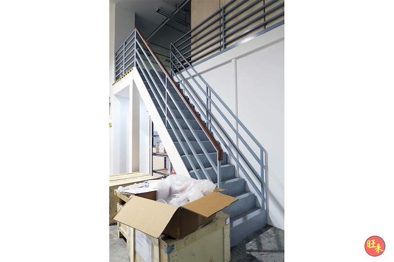 Steel staircase with tubular handrails rising to the mezzanine floor, cartons stored beneath - V5000 Racking - V5-19 | Wong Lye Racking, Singapore Racking Manufacturer