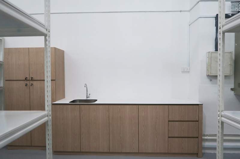 Sink counter with timber-laminate cabinets flanked by boltless shelving uprights - Boltless Racking - B8 | Wong Lye Racking, Singapore Racking Manufacturer