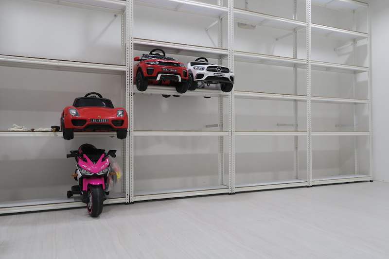 Run of white boltless shelving with toy cars on the lower shelves, upper shelves empty - Boltless Racking - B3 | Wong Lye Racking, Singapore Racking Manufacturer