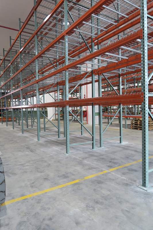 End of a pallet racking run with green uprights and orange beams along a yellow aisle line - V3000 Racking - V3-3 | Wong Lye Racking, Singapore Racking Manufacturer