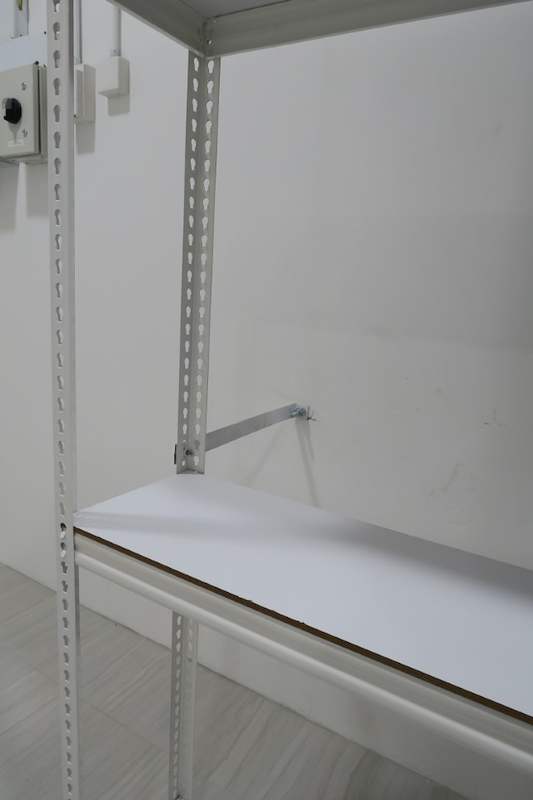 Wall tie bracket fixing a white boltless shelving upright to the wall - Boltless Racking - B3 | Wong Lye Racking, Singapore Racking Manufacturer