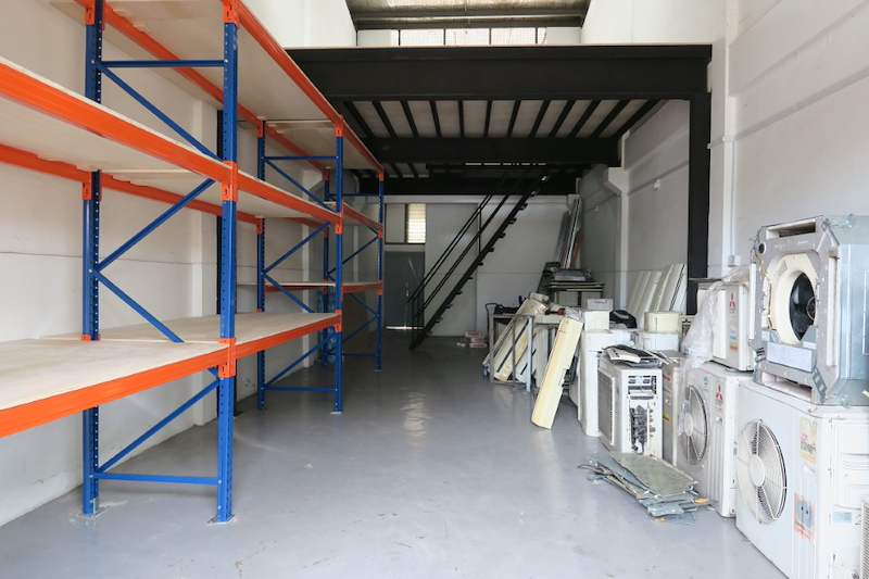 Racking bays with plywood decking along the wall, air-conditioning units on the floor and mezzanine behind - V3000 Racking - V3-2 | Wong Lye Racking, Singapore Racking Manufacturer