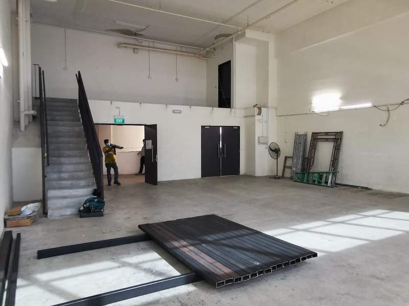 Mezzanine deck panels and steel sections laid out below the staircase during installation - V5000 Racking - V5-9 | Wong Lye Racking, Singapore Racking Manufacturer