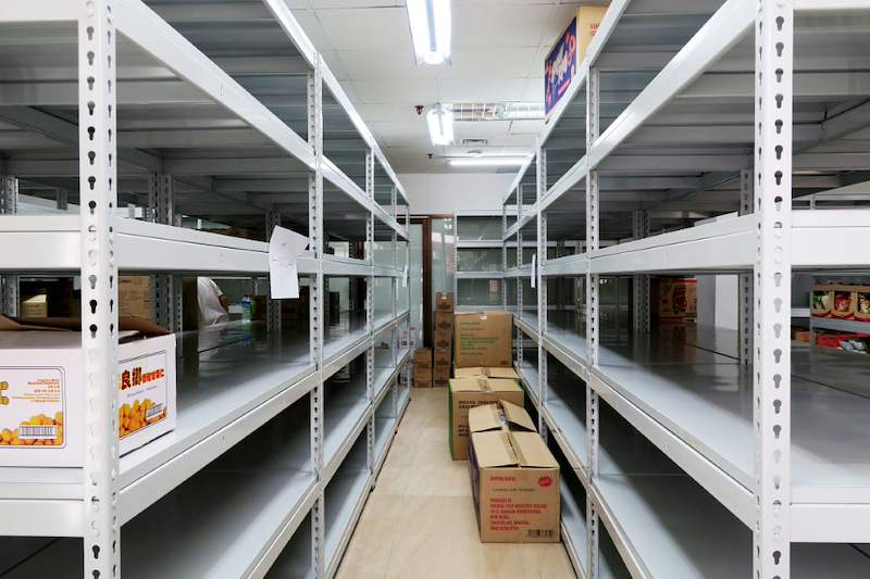 Aisle between boltless shelving rows with cartons on the floor and lower shelves - Boltless Racking - B2 | Wong Lye Racking, Singapore Racking Manufacturer