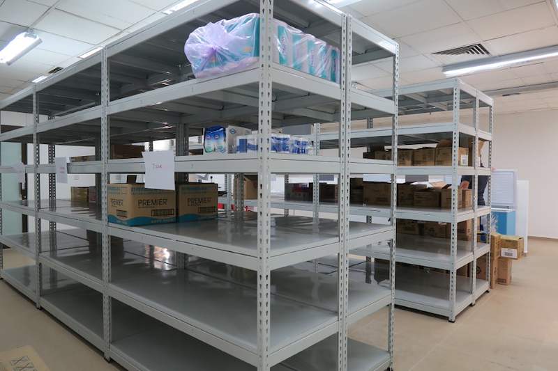 Grey boltless shelving bay with cartons and packaged goods on the middle levels - Boltless Racking - B2 | Wong Lye Racking, Singapore Racking Manufacturer