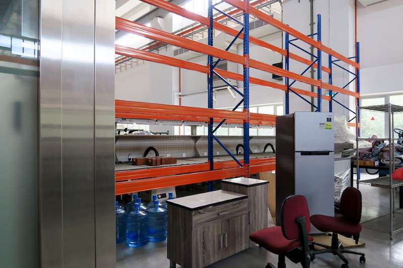 V3000 racking bays with a workbench, chairs and a refrigerator beneath the first level - V3000 Racking - V3-5 | Wong Lye Racking, Singapore Racking Manufacturer