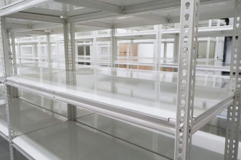 White boltless shelving with steel shelf panels seen from inside a bay, more rows beyond - Boltless Racking - B8 | Wong Lye Racking, Singapore Racking Manufacturer