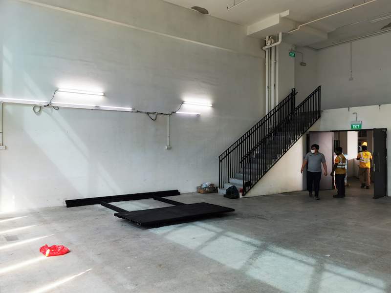 Installers by the staircase with mezzanine deck panels staged on the floor - V5000 Racking - V5-9 | Wong Lye Racking, Singapore Racking Manufacturer