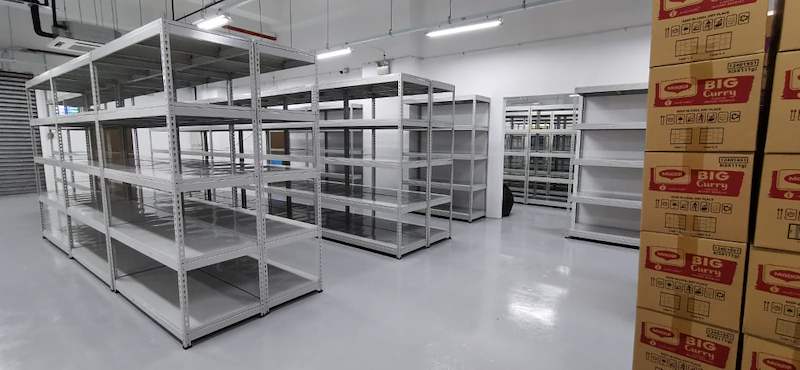 Grey boltless shelving blocks with cartons of stock stacked beside them - Boltless Racking - B1 | Wong Lye Racking, Singapore Racking Manufacturer