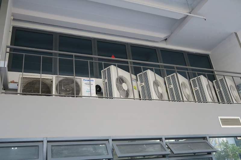 Condenser units lined along the railed ledge above the windows - Boltless Racking - B8 | Wong Lye Racking, Singapore Racking Manufacturer