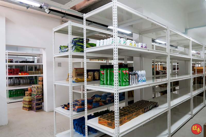 White boltless shelving units stocked with drinks and packaged food, viewed from the end of the room - Boltless Racking - B6 | Wong Lye Racking, Singapore Racking Manufacturer