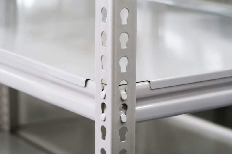 Close view of a white boltless shelving upright with keyhole slots and a steel shelf edge - Boltless Racking - B8 | Wong Lye Racking, Singapore Racking Manufacturer
