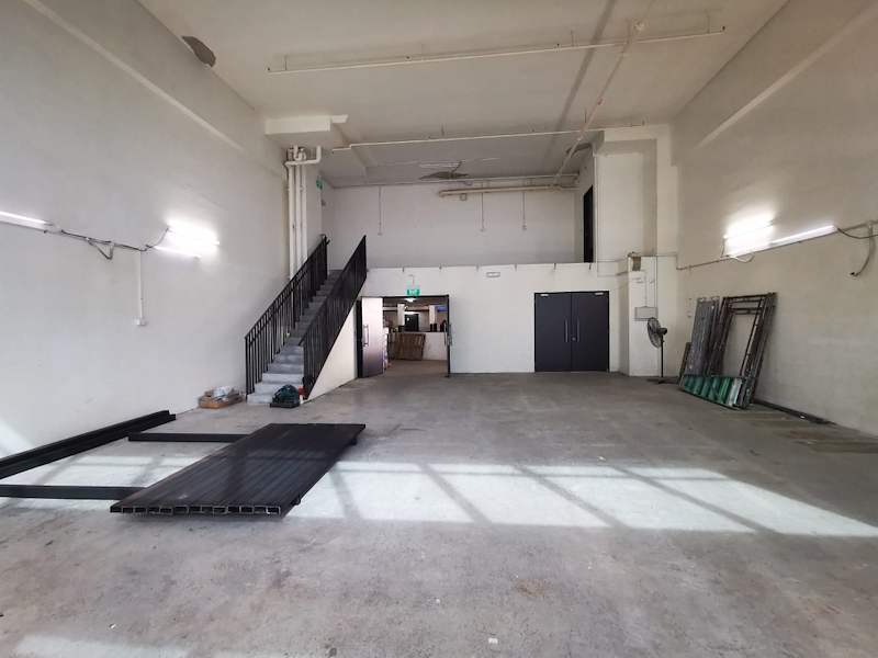 Mezzanine staircase against the wall with deck panels staged on the empty floor - V5000 Racking - V5-9 | Wong Lye Racking, Singapore Racking Manufacturer