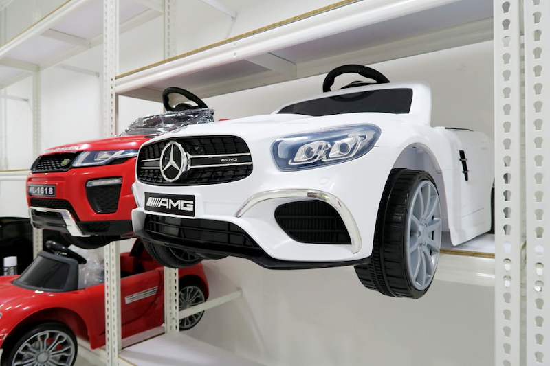 White ride-on toy car with a red toy car beside it on white boltless shelving - Boltless Racking - B3 | Wong Lye Racking, Singapore Racking Manufacturer