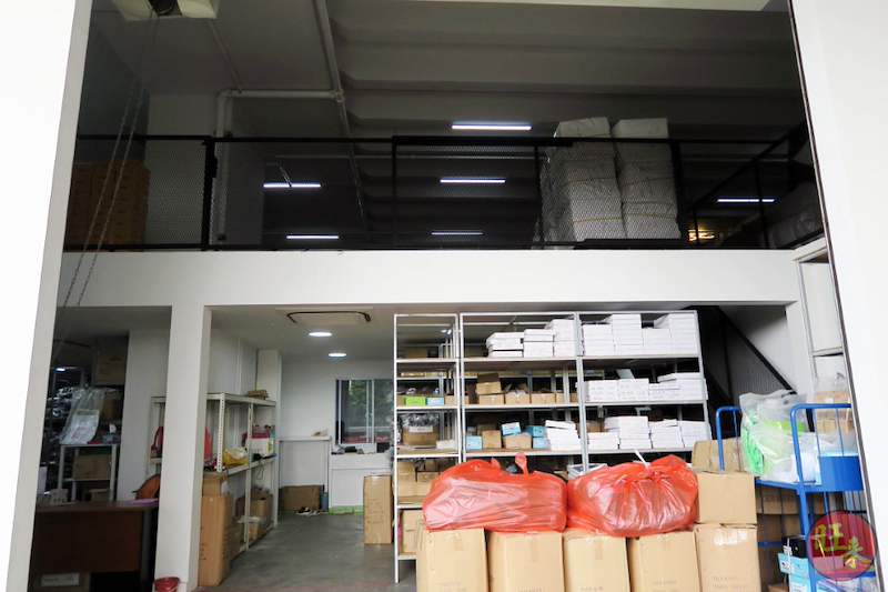 Ground-floor view of the mezzanine structure and boltless shelving stocked with cartons and bagged goods - V8000 Racking - V8-20 | Wong Lye Racking, Singapore Racking Manufacturer