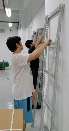Two installers standing up a boltless shelving frame during assembly - Boltless Racking - B1 | Wong Lye Racking, Singapore Racking Manufacturer