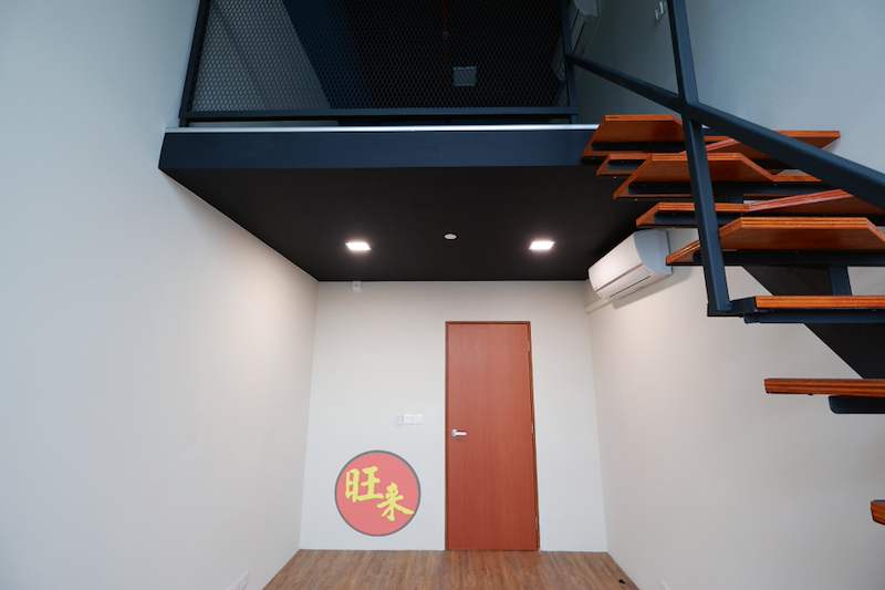 Loft mezzanine with black mesh railing above a doorway, timber-tread staircase to one side - V5000 Racking - V5-26 | Wong Lye Racking, Singapore Racking Manufacturer