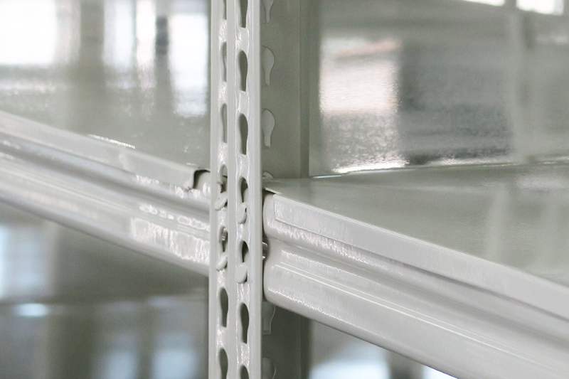 Corner detail of white boltless shelving showing the slotted upright and shelf beam junction - Boltless Racking - B8 | Wong Lye Racking, Singapore Racking Manufacturer