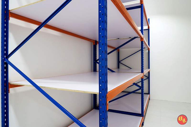 Blue-and-orange long-span racking with white board decking against the wall, close view - Boltless Racking - B3 | Wong Lye Racking, Singapore Racking Manufacturer