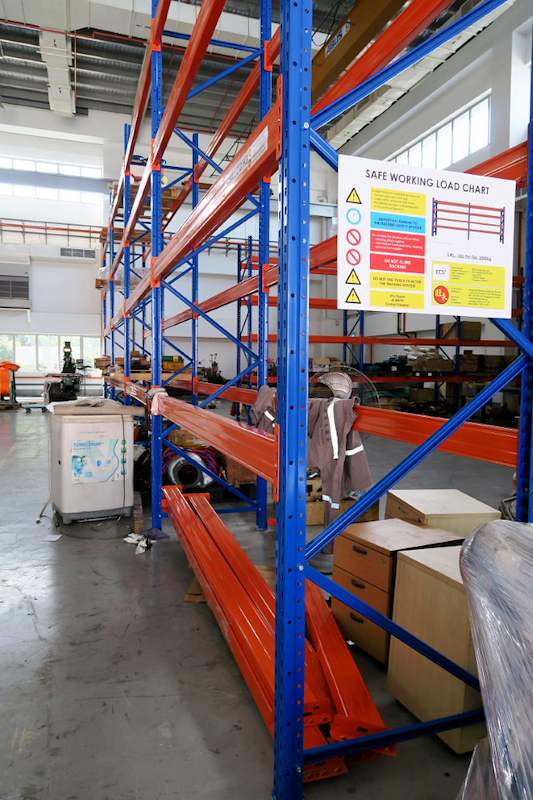 End frame of the V3000 racking with the load chart on the upright and cartons below - V3000 Racking - V3-5 | Wong Lye Racking, Singapore Racking Manufacturer