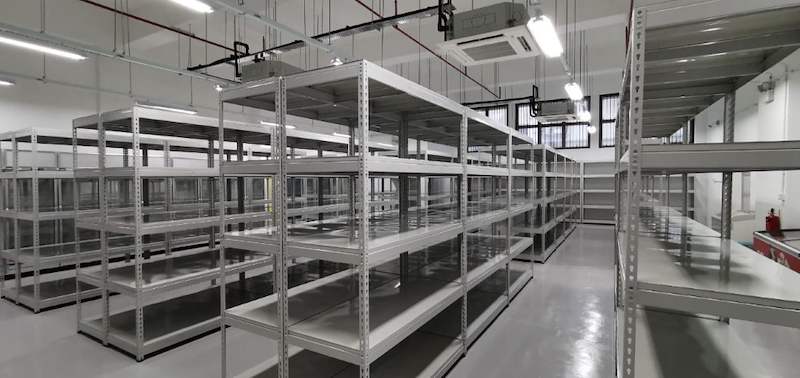Rows of grey boltless shelving across the store under ceiling cassette air-conditioning - Boltless Racking - B1 | Wong Lye Racking, Singapore Racking Manufacturer