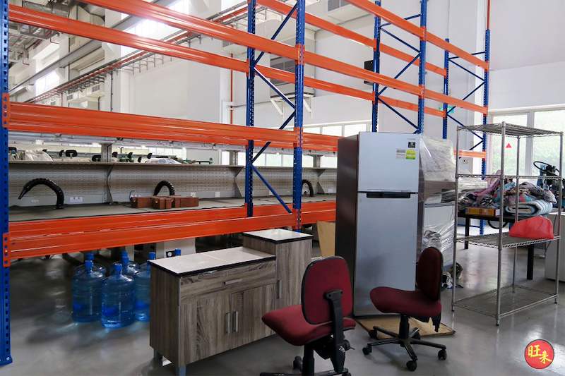 V3000 racking bays over a workbench, chairs and a refrigerator with wire shelving alongside - V3000 Racking - V3-5 | Wong Lye Racking, Singapore Racking Manufacturer