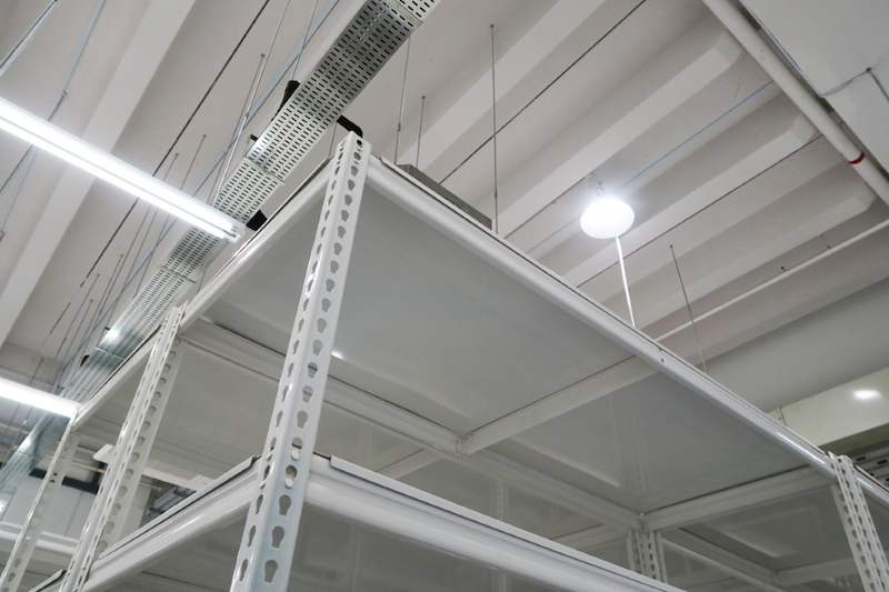 Looking up between white boltless shelving uprights to the ceiling lighting and ducting - Boltless Racking - B8 | Wong Lye Racking, Singapore Racking Manufacturer