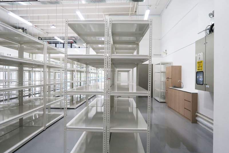 White boltless shelving rows beside a pantry counter and door in the store - Boltless Racking - B8 | Wong Lye Racking, Singapore Racking Manufacturer