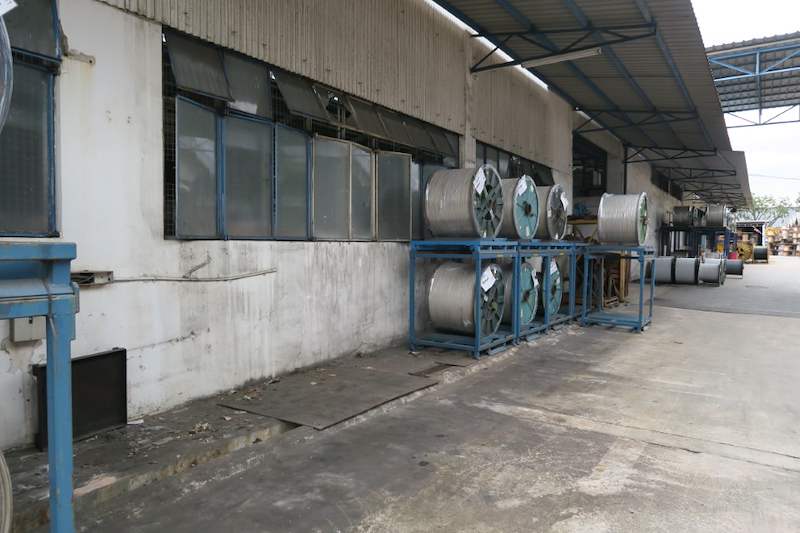 Before: cable drums stored on low blue steel stands along the same wall before the rack was built - V5000 Racking - V5-1 | Wong Lye Racking, Singapore Racking Manufacturer