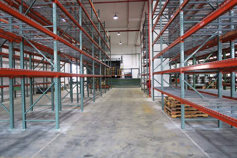 Aisle between two pallet racking runs with mesh decking, pallets stored at the far end - V3000 Racking - V3-3 | Wong Lye Racking, Singapore Racking Manufacturer