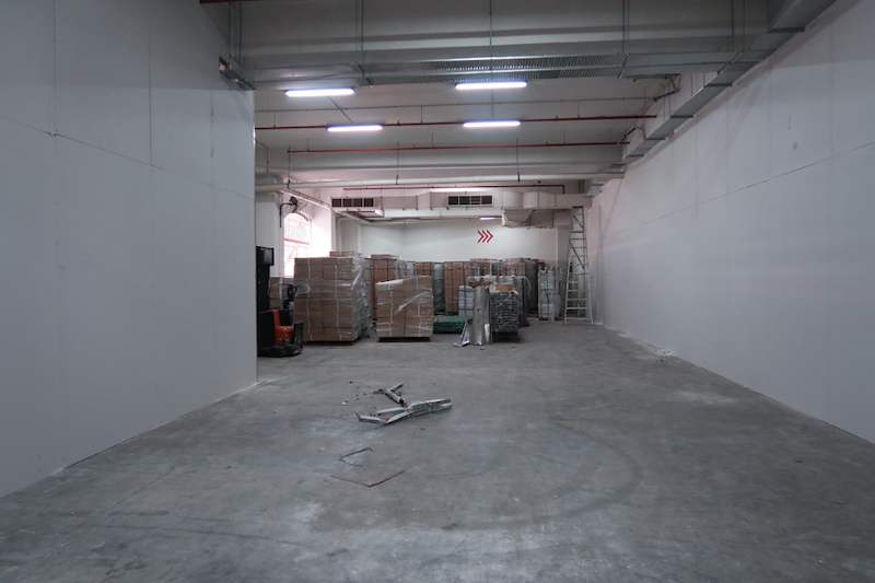 Before: partition walls in place and pallets of materials by the door, concrete floor bare - Boltless Racking - B7 | Wong Lye Racking, Singapore Racking Manufacturer