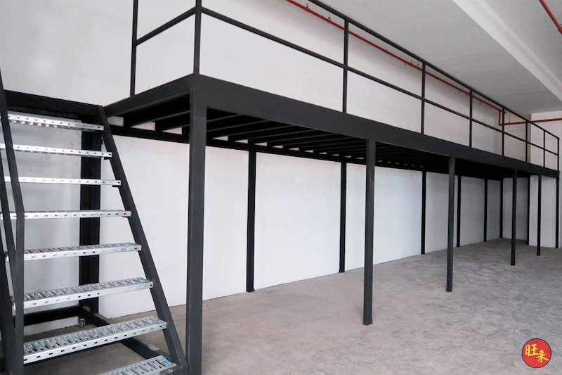 Steel staircase with perforated treads beside the black mezzanine deck and its railing - V5000 Racking - V5-17 | Wong Lye Racking, Singapore Racking Manufacturer