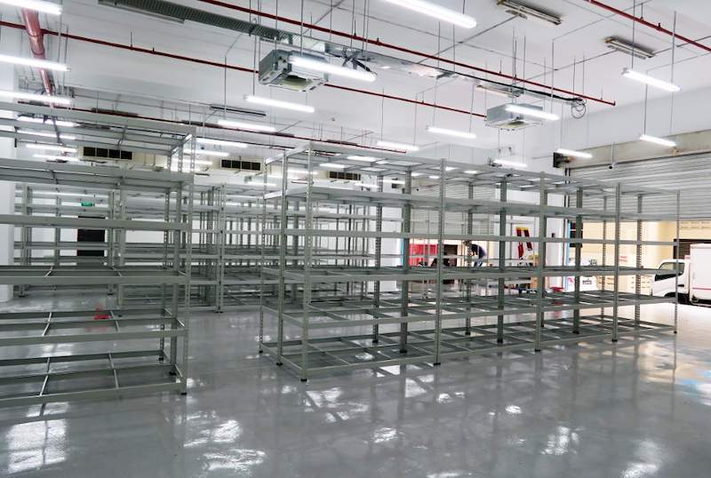 Beige boltless shelving units assembled in blocks on the new epoxy floor, install in progress - Boltless Racking - B7 | Wong Lye Racking, Singapore Racking Manufacturer