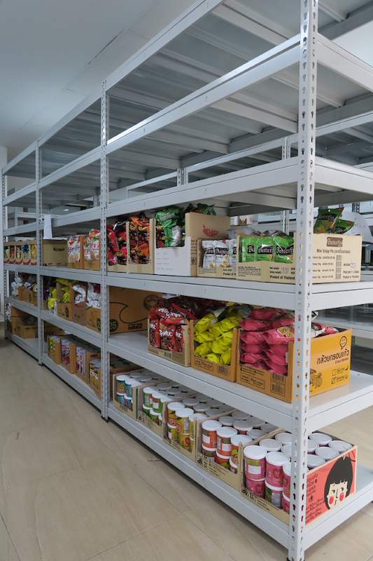 Grey boltless shelving bay with bagged snacks and canned goods on the lower shelves - Boltless Racking - B2 | Wong Lye Racking, Singapore Racking Manufacturer