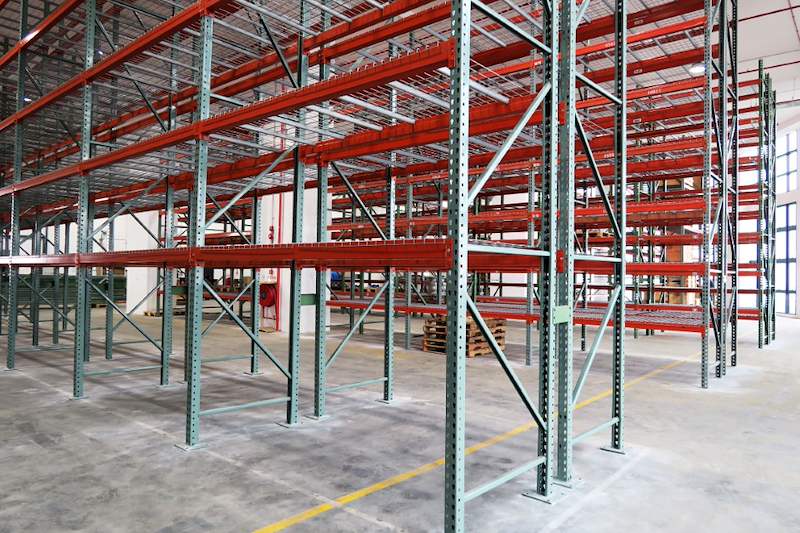 Green-upright pallet racking with orange beams and wire mesh decks, bays empty - V3000 Racking - V3-3 | Wong Lye Racking, Singapore Racking Manufacturer