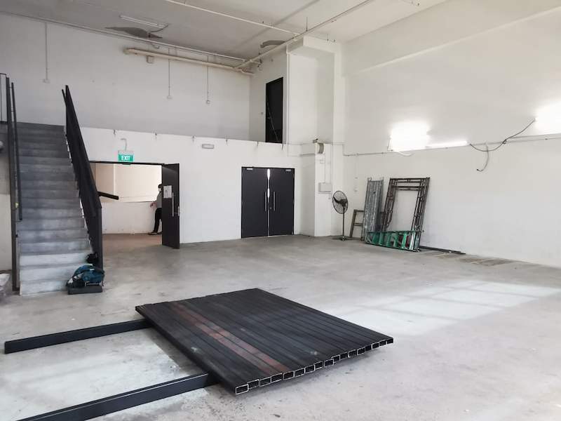 Deck panels stacked on the floor beside the staircase during the mezzanine installation - V5000 Racking - V5-9 | Wong Lye Racking, Singapore Racking Manufacturer