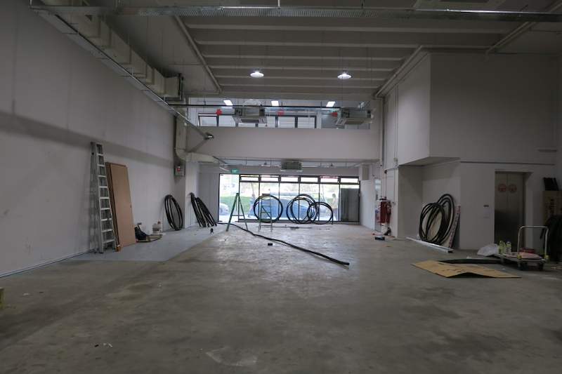 Before: bare unit interior with cable coils and a ladder against the wall - Boltless Racking - B8 | Wong Lye Racking, Singapore Racking Manufacturer
