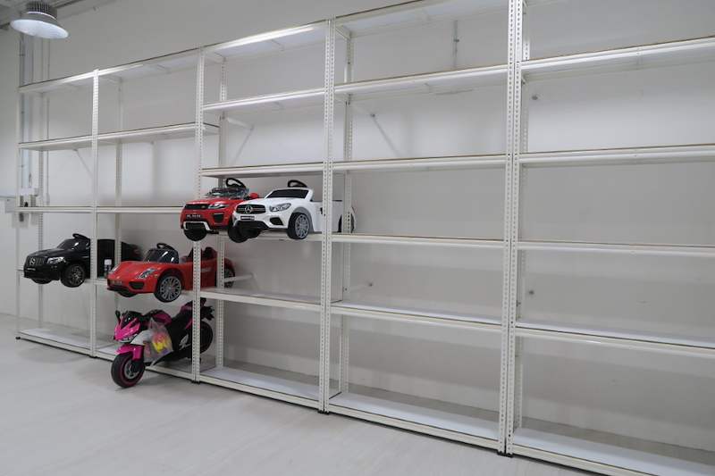 White boltless shelving run with ride-on toy cars and a toy motorcycle on the lower shelves - Boltless Racking - B3 | Wong Lye Racking, Singapore Racking Manufacturer