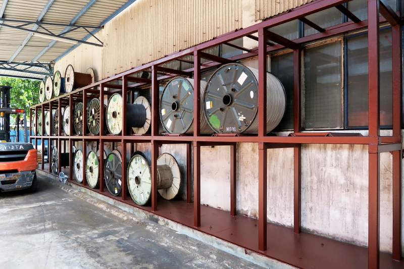 Two-tier welded steel rack under a shed roof loaded with cable drums on their sides - V5000 Racking - V5-1 | Wong Lye Racking, Singapore Racking Manufacturer