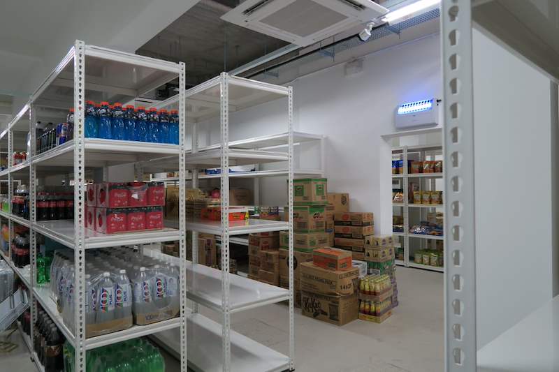 Boltless shelving bay of bottled drinks with cartons of stock on the floor behind - Boltless Racking - B6 | Wong Lye Racking, Singapore Racking Manufacturer