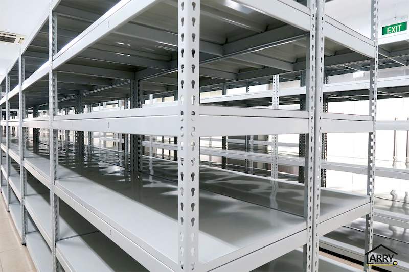Boltless shelving rows in the tiled room with an exit sign above, shelves empty - Boltless Racking - B5 | Wong Lye Racking, Singapore Racking Manufacturer