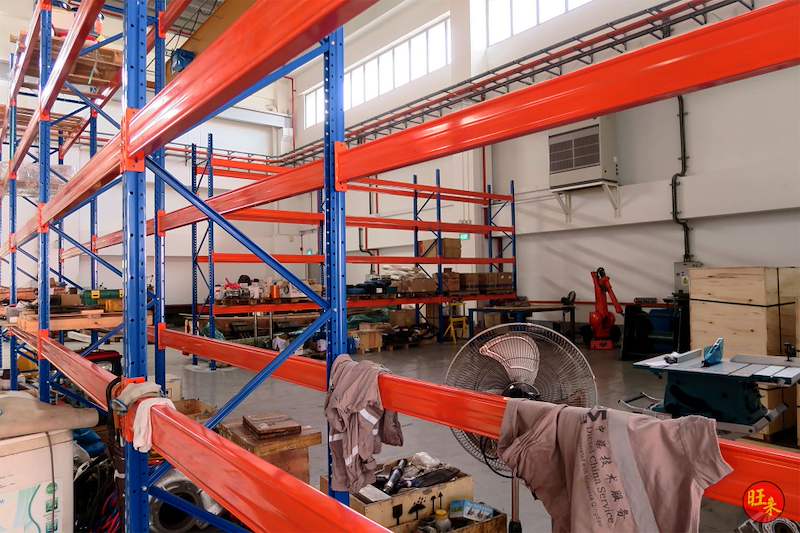 Orange beams and blue uprights of the V3000 racking above workshop tools and parts - V3000 Racking - V3-5 | Wong Lye Racking, Singapore Racking Manufacturer