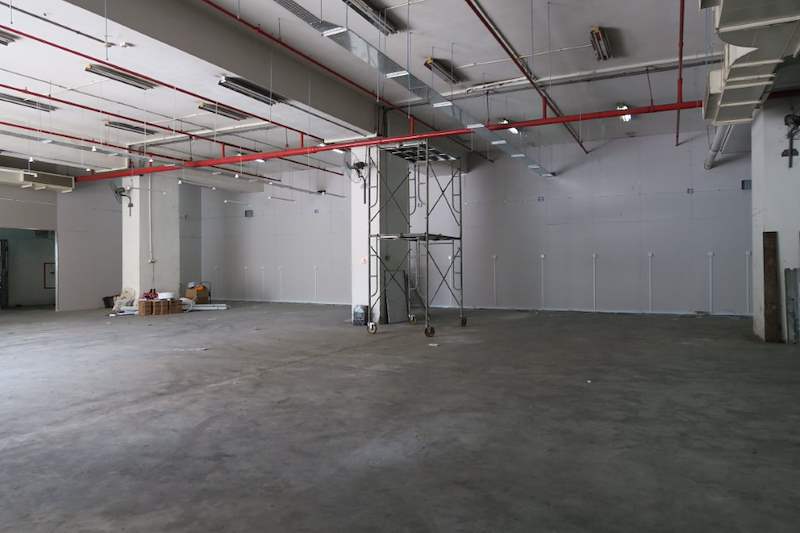 Before: empty warehouse unit with mobile scaffold, before the shelving was installed - Boltless Racking - B7 | Wong Lye Racking, Singapore Racking Manufacturer