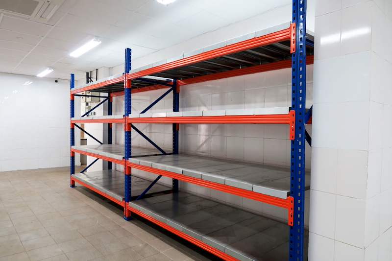 End of the long-span racking run showing the blue upright frame and orange beams with steel decking - Boltless Racking - B5 | Wong Lye Racking, Singapore Racking Manufacturer