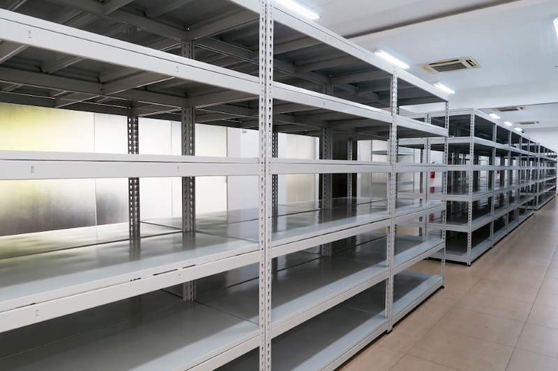 Boltless shelving rows with steel shelf panels seen from the end of the room - Boltless Racking - B5 | Wong Lye Racking, Singapore Racking Manufacturer